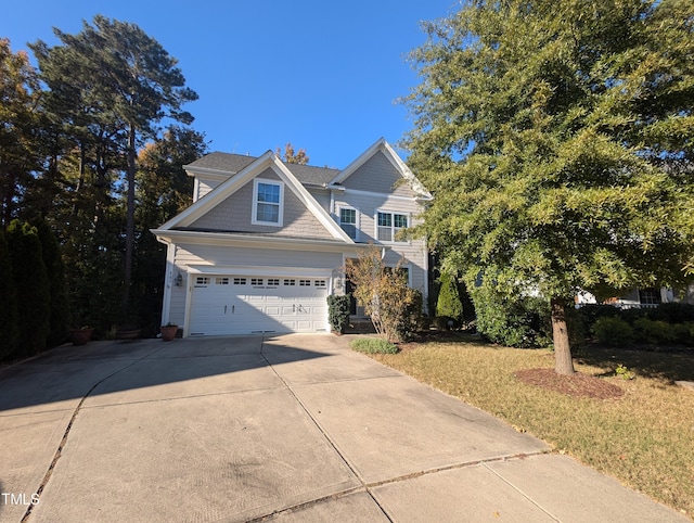 view of front of home featuring a front yard and a garage