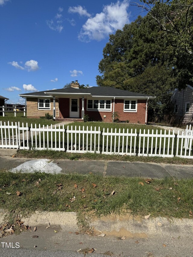 405 Whitfield Dr, Goldsboro, NC 27530 - ranch-style house featuring a chimney and brick siding