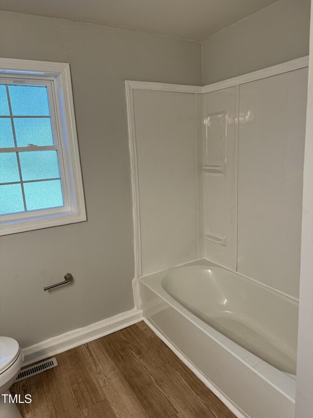 405 Whitfield Dr, Goldsboro, NC 27530 - full bath with toilet, wood finished floors, baseboards, and shower / tub combination