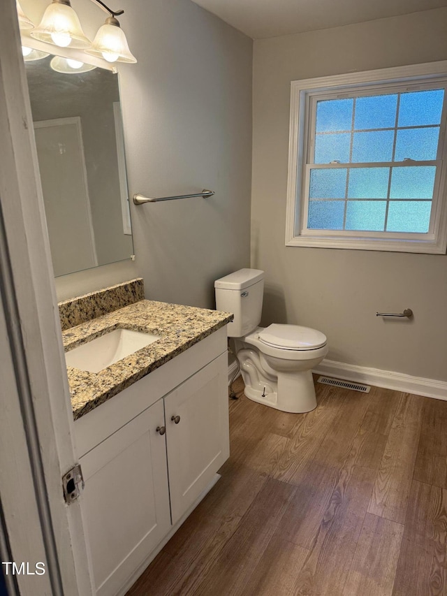 405 Whitfield Dr, Goldsboro, NC 27530 - bathroom featuring wood finished floors, toilet, vanity, and baseboards