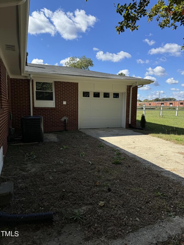405 Whitfield Dr, Goldsboro, NC 27530 - garage featuring driveway and central air condition unit