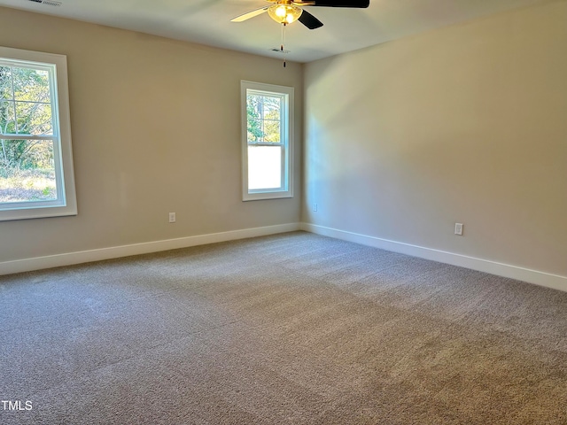 spare room with ceiling fan and carpet