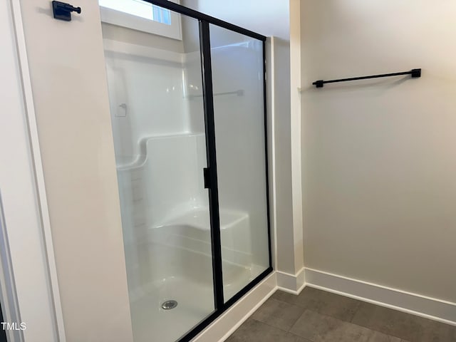 bathroom with tile patterned floors and an enclosed shower