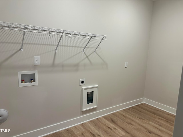 laundry area with hardwood / wood-style floors, electric dryer hookup, heating unit, and washer hookup