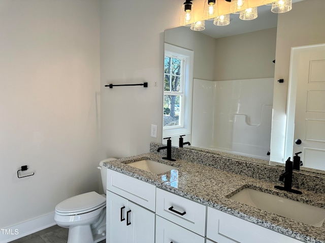 bathroom featuring tile patterned floors, vanity, toilet, and walk in shower