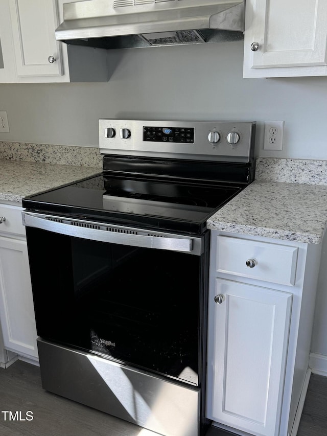913 Greenleaf St, Goldsboro, NC 27530 - kitchen featuring electric stove, under cabinet range hood, white cabinets, and wood finished floors