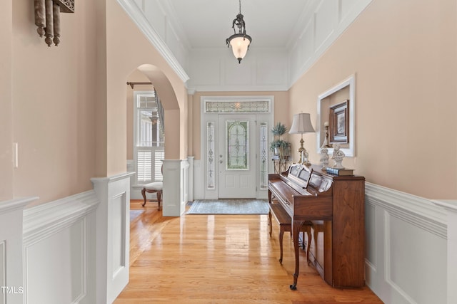 entrance foyer featuring light hardwood / wood-style flooring and ornamental molding