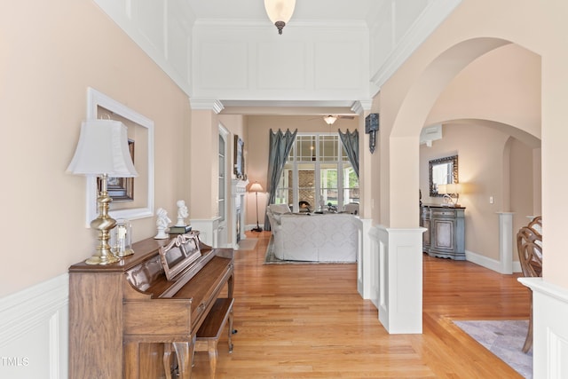 corridor featuring light hardwood / wood-style flooring and crown molding