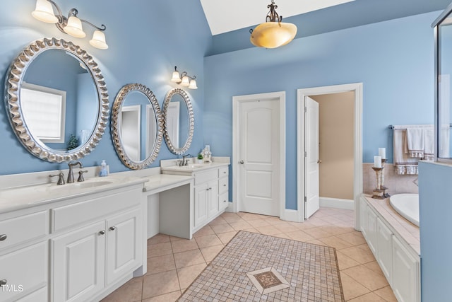 bathroom with vanity, lofted ceiling, tile patterned floors, and a washtub