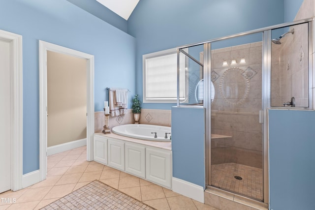 bathroom with tile patterned floors, vaulted ceiling, and plus walk in shower