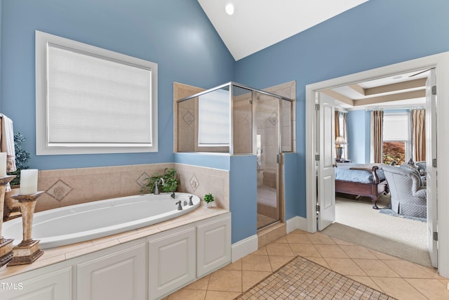 bathroom with separate shower and tub, vaulted ceiling, and tile patterned floors