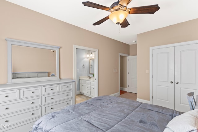 tiled bedroom featuring a closet, connected bathroom, and ceiling fan