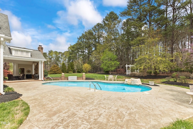 view of pool with a yard and a patio area