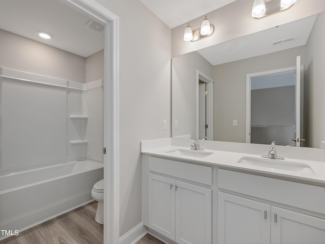 full bathroom with vanity,  shower combination, toilet, and wood-type flooring