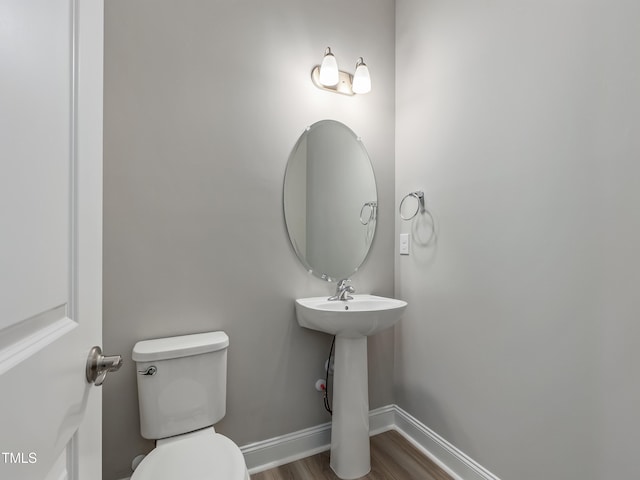 bathroom with sink, toilet, and hardwood / wood-style flooring