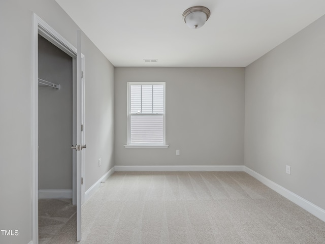 unfurnished room with light carpet