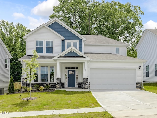 craftsman inspired home featuring a front yard and a garage