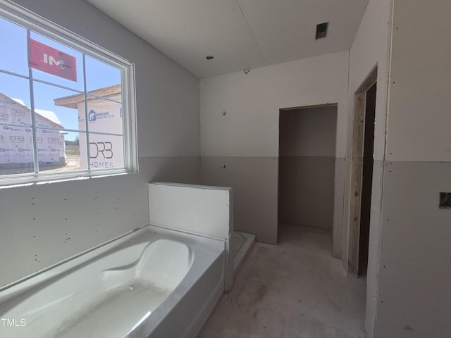 236 Alden Way, Angier, NC 27501 - bathroom featuring concrete flooring and a bath
