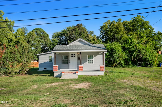 bungalow-style house with a front yard and covered porch