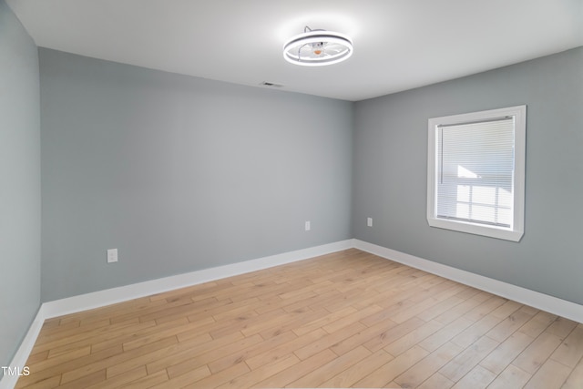 spare room with light hardwood / wood-style flooring