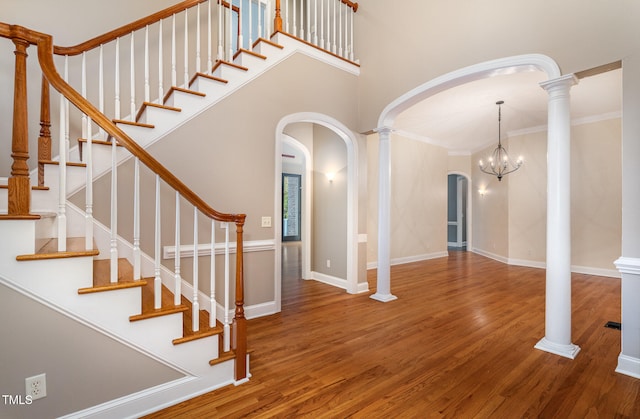 interior space with a chandelier, hardwood / wood-style floors, and crown molding