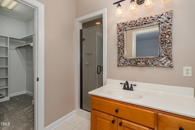 bathroom with tile patterned floors, vanity, and an enclosed shower