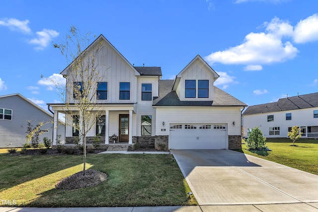 view of front of home with a garage, covered porch, and a front yard