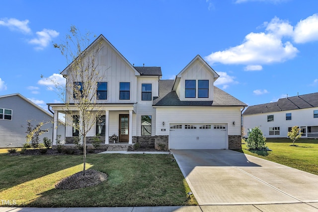 view of front of home featuring a porch, a front yard, board and batten siding, concrete driveway, and an attached garage