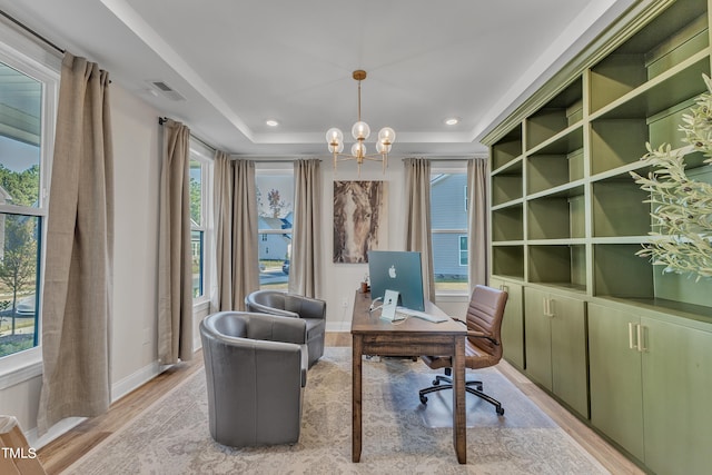 office space featuring light hardwood / wood-style floors, a chandelier, and a healthy amount of sunlight