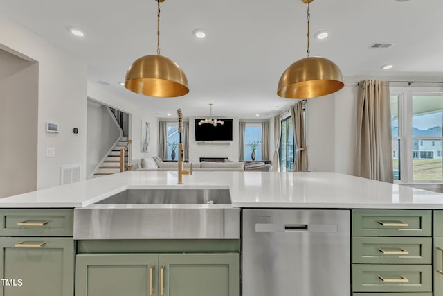 kitchen featuring green cabinets, tasteful backsplash, a fireplace, dishwasher, and pendant lighting