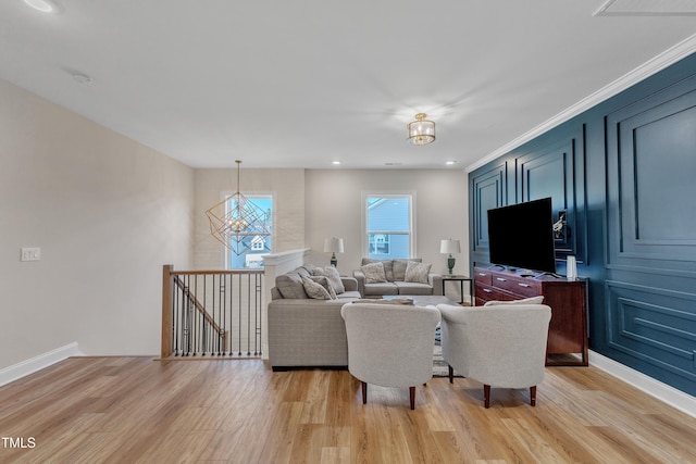 living room featuring light wood-style floors, recessed lighting, a notable chandelier, and baseboards