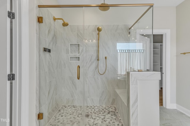full bathroom featuring a marble finish shower