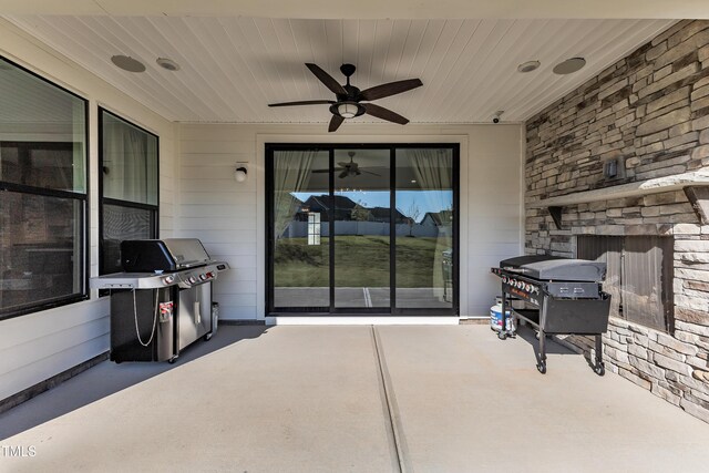 616 Silver Comet Dr, Knightdale, NC 27545 - view of patio featuring grilling area, an outdoor stone fireplace, and a ceiling fan
