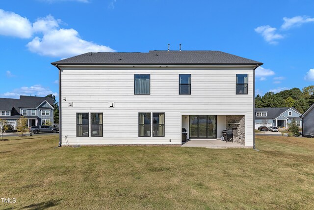 back of house with a yard and a patio