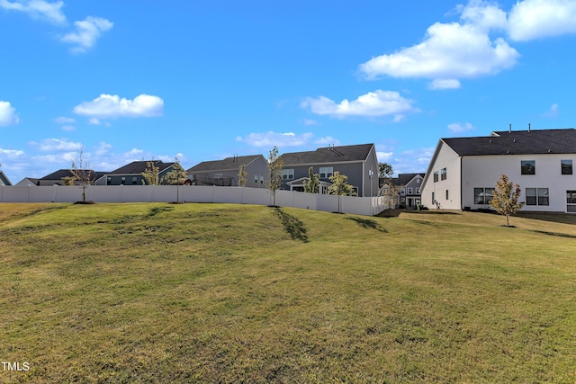 view of yard with fence and a residential view