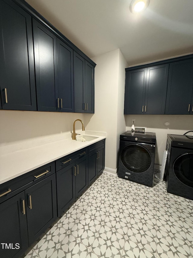 washroom with sink, washing machine and clothes dryer, and cabinets