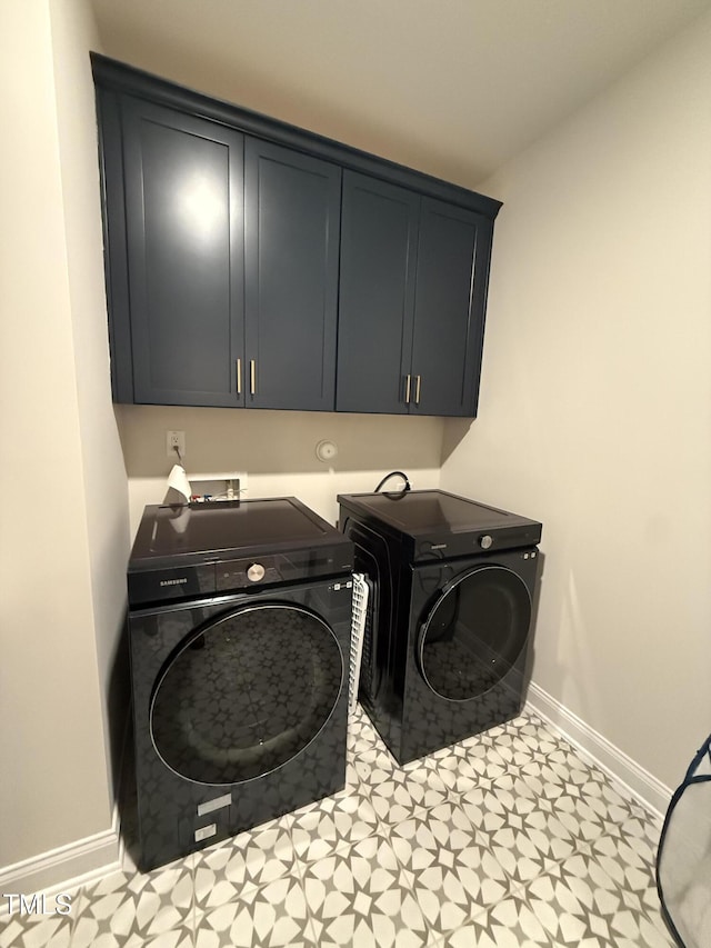 washroom featuring cabinets and independent washer and dryer