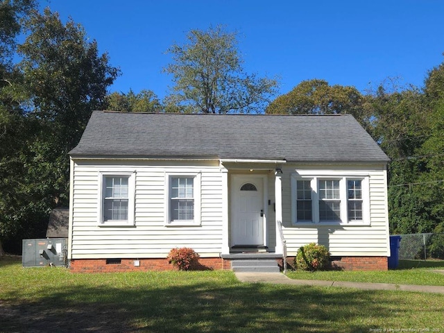 view of front of home with central AC and a front yard