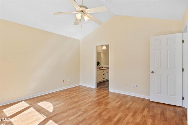 unfurnished bedroom with connected bathroom, lofted ceiling, light hardwood / wood-style floors, and ceiling fan