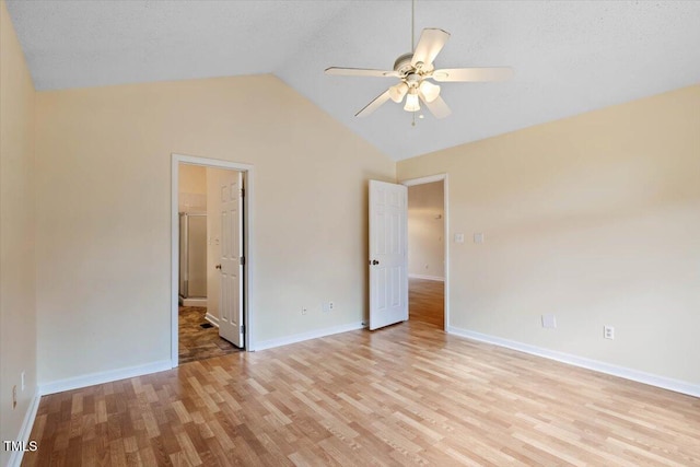 unfurnished bedroom featuring lofted ceiling, light wood-type flooring, and ceiling fan