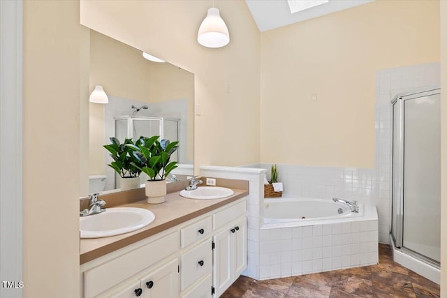 bathroom with vanity and shower with separate bathtub