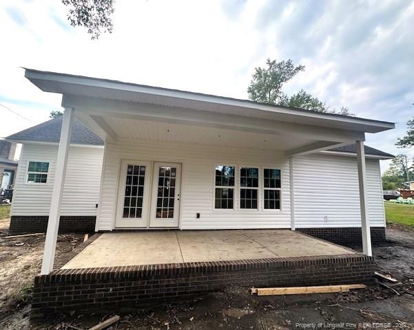 back of property with a patio