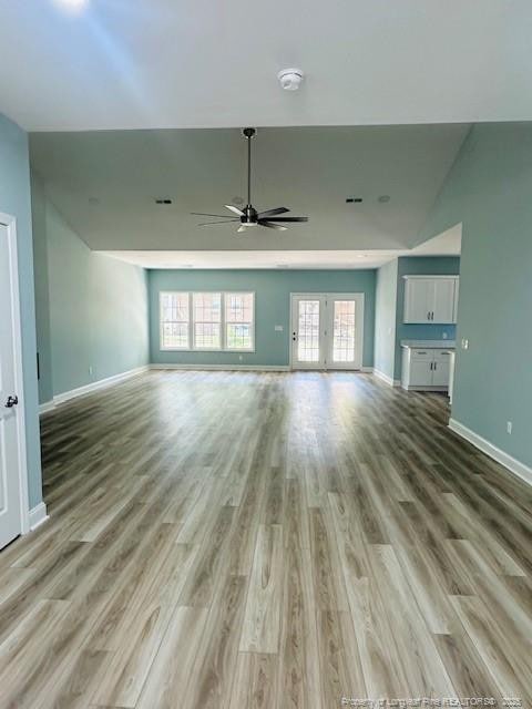 1361 7th St SE, Lumberton, NC 28358 - unfurnished living room featuring ceiling fan, lofted ceiling, baseboards, and light wood-type flooring