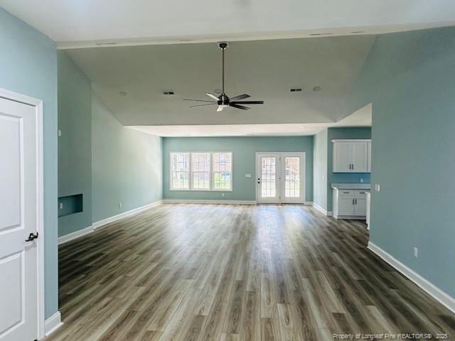 1361 7th St SE, Lumberton, NC 28358 - unfurnished living room featuring a ceiling fan, wood finished floors, baseboards, and lofted ceiling