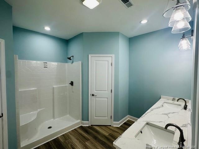 1361 7th St SE, Lumberton, NC 28358 - bathroom with wood finished floors, baseboards, double vanity, a shower, and recessed lighting