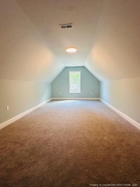 1361 7th St SE, Lumberton, NC 28358 - additional living space with carpet flooring, vaulted ceiling, and baseboards