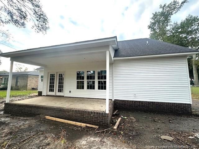 1361 7th St SE, Lumberton, NC 28358 - back of property featuring a patio and a shingled roof