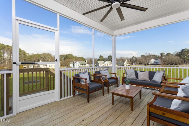 sunroom featuring ceiling fan