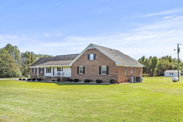 2554 Davis Mill Rd, Fremont, NC 27830 - view of front of house featuring a front yard, central air condition unit, a porch, and brick siding