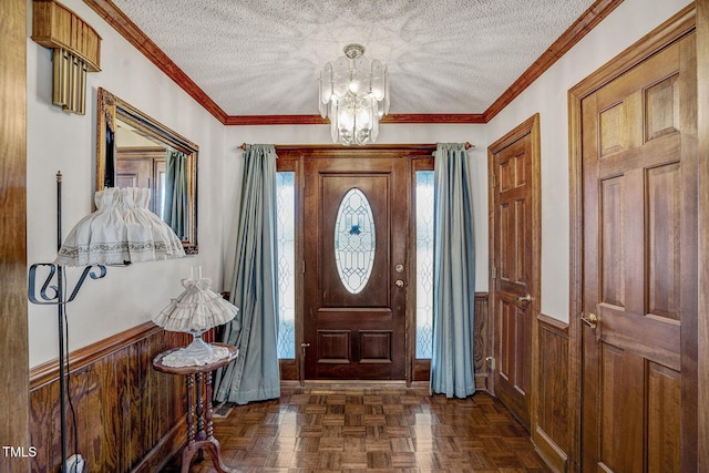 2554 Davis Mill Rd, Fremont, NC 27830 - foyer featuring a textured ceiling, wainscoting, a chandelier, wood walls, and crown molding